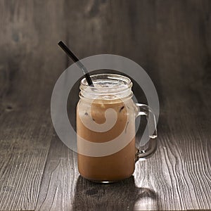 Ice Milo with straw served in mug isolated on table side view healthy morning drink