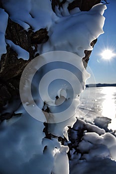 Ice over the rocks. Ice over rocks wall on Baikal lake at winter.