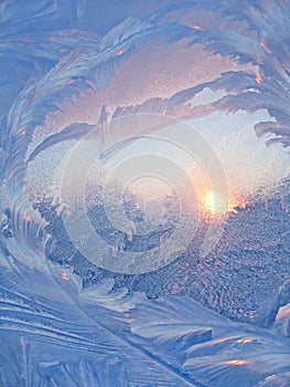 Ice pattern and sunlight on winter glass