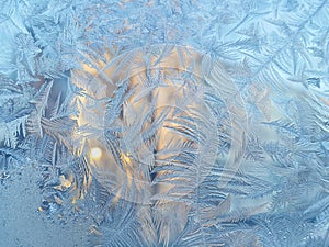 Ice pattern and sunlight on winter glass