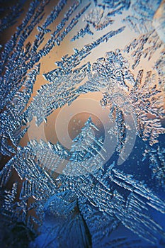 Ice Pattern on winter Glass in the frost at sunset. Ice Pattern on glass are shot in macro. Ice Pattern on glass look futuristic a