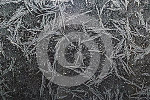 Ice patterns on glass on Christmas Eve. winter background