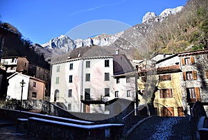 Ice on the petra of the sun bridge over the houses and mountains in Fornovolasco.