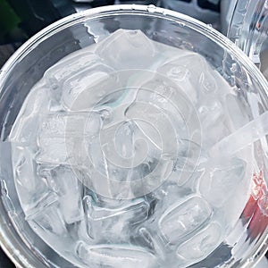 Ice in a plastic cup sitting in car cupholder photo
