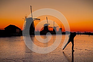 Ice skater in front of the Kinderdijk windmills