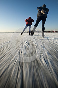 Ice skaters on a frozen lake. photo