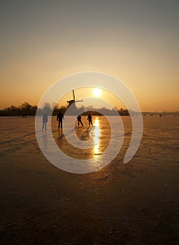 Ice skaters on a frozen lake in Rotterdam The Netherlands photo