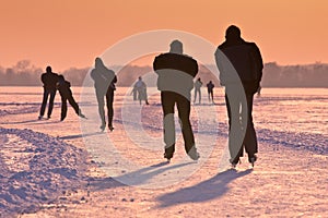 Ice Skaters under setting sun