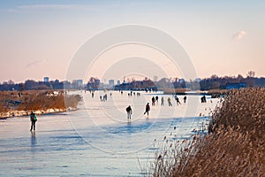 Ice skaters on frozen water in Holland