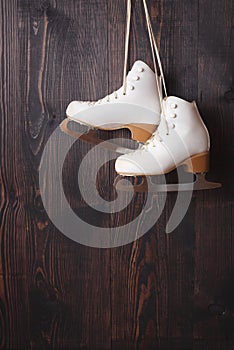 Ice skates on a wooden background