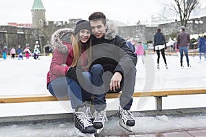 Ice skating couple having winter fun on ice skates