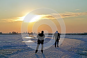 Ice skating in the Netherlands at sunset
