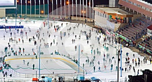 Ice skating rink whith motion blurred large group of skating peo