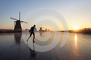 Ice skating at sunrise in the Netherlands photo