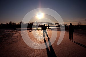 Ice skating at sunset in the Netherlands