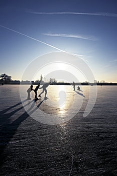 Ice skating at sunset in the Netherlands