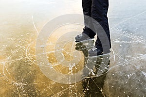 The ice skating tracks, a man stands beside her.