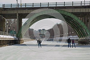 Ice skating under the bridge on the frozen Rideau Canal Ottawa W