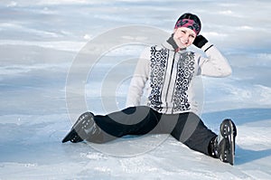 Ice skating woman sitting on ice