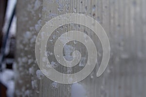 Ice and snow on the glass wall of the house