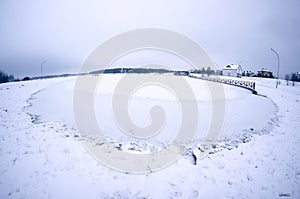 Ice and snow on pond. Winter landscape