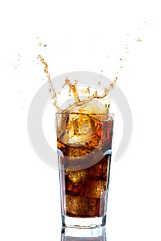 Ice splashing on a glass of a Cola drink