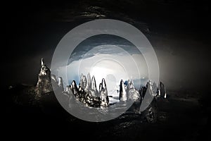 Ice stalagmite in a dark cave