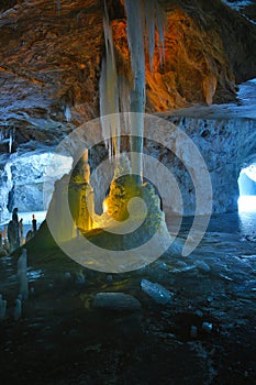 Ice stalagmites and stalactites illuminated by candles inside the marble mine