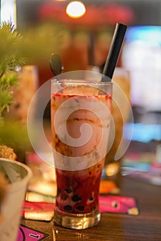 ice strawberry boba with straw and spoon