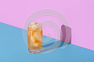 Ice tea glass isolated on a vibrant colored background