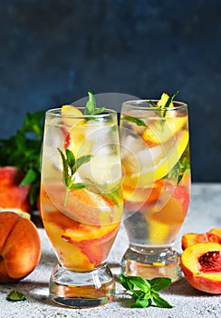 Ice tea with peach and lemon. Cold drink.