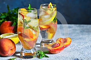 Ice tea with peach and lemon. Cold drink.