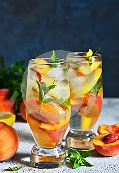 Ice tea with peach and lemon. Cold drink.