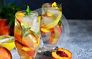 Ice tea with peach and lemon. Cold drink.