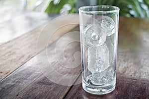 Ice tube in glass on table