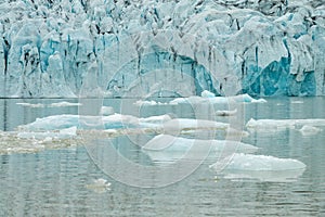 Ice wall and icebergs in Fjallsarlon glacier lagoon, abstract landscape Iceland