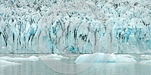 Ice wall and icebergs panorama in Fjallsarlon glacier lagoon Iceland