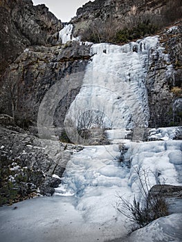 Ice waterfall between rock walls, in the northern hills of Guadalajara, Valverde de los Arroyos, Spain photo