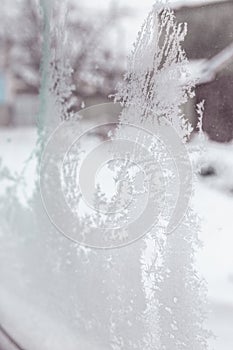 Ice on a window. Winter ice frost, frozen background. frosted window glass texture. Cold cool icicles background