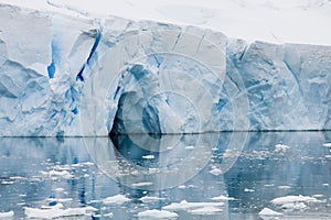 Iceberg in Antarctica, huge table iceberg, tabular iceberg with gate and reflections