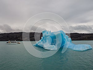 Iceberg and boat comparation in Lake Argentina in front of tha U