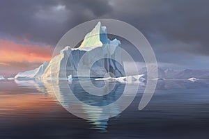 iceberg calving with rainbow reflecting on water