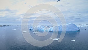 Iceberg float in clear water ocean aerial view