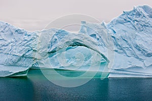 Iceberg with gate in Antarctica. Antarctic iceberg with turquoise  water in dark blue ocean .