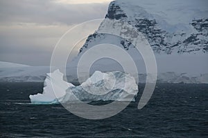 Iceberg glowing in overcast dawn