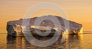 Iceberg in Greenland during sunset. photo