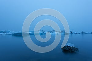 Iceberg in lagoon at midnight. Long exposure