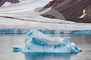 Iceberg next to the edge of a glacier in Ellesmere Island, part of the Qikiqtaaluk Region in the Canadian territory of