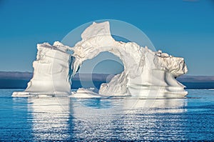 Iceberg in the ocean. Blue sky. Disko Bay, Western Greenland.