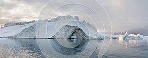 Iceberg at sunset. Nature and landscapes of Greenland. Disko bay. Summer Midnight Sun and icebergs. Big blue ice in icefjord.